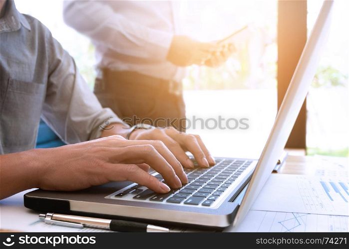 Cropped image of handsome businessmen using laptop at a office