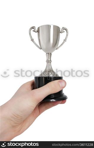 Cropped image of man&acute;s hand holding winning trophy over white background