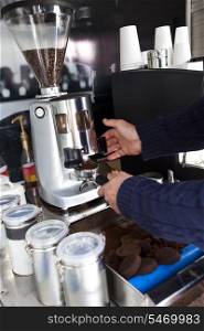 Cropped image of man preparing coffee at mobile coffee shop