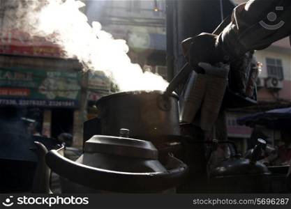 Cropped image of vendor making tea