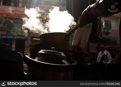Cropped image of vendor preparing tea