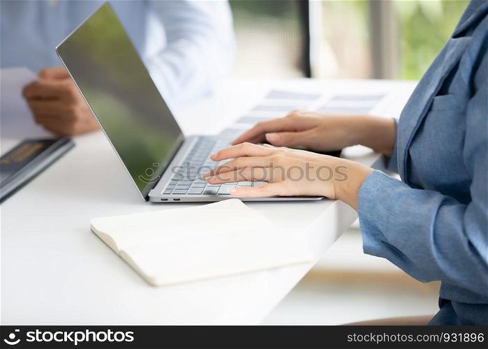 cropped image on business women hands typing on laptop in office