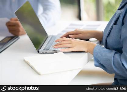 cropped image on business women hands typing on laptop in office