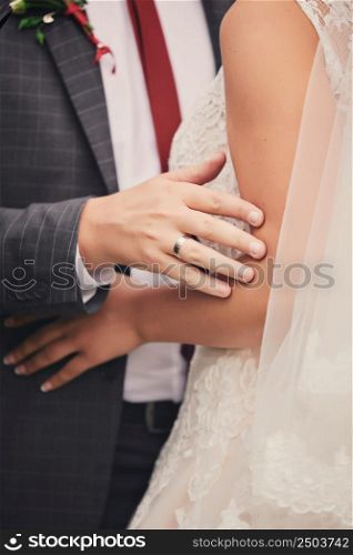 cropped photo of couple in love, bride and groom cuddle and look at each other. This day is the first of many beautiful days together. cropped photo of couple in love, bride and groom cuddle and look at each other. This day is the first of many beautiful days together.