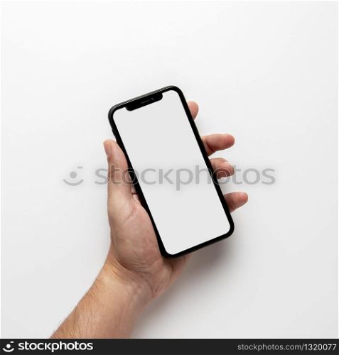Cropped photo of male hand holding smartphone