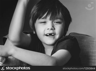 Cropped short kid looking at camera with smiling face,Candid short child showing lost his baby front teeth with big smile, close up face of little boy show his milk tooth fell out,Dental hygiene