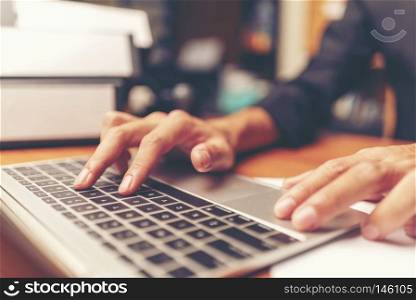 Cropped shot of a man&rsquo;s hands using a laptop at home, rear view of business man hands busy using laptop at office desk, young male student typing on computer sitting at wooden table