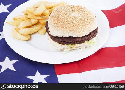 Cropped shot of chips and burger over America flag