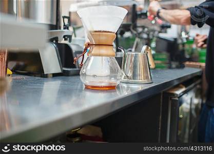 Cropped shot of male barista preparing coffee in cafe