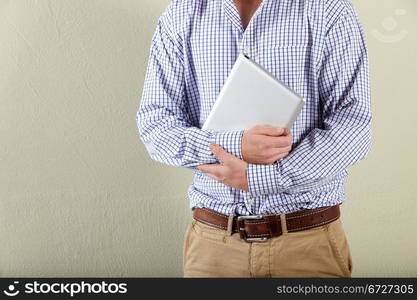 Cropped Studio Shot Of Young Man Holding Tablet Computer