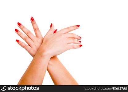 Cropped view of hands crossed at the wrists against a white background