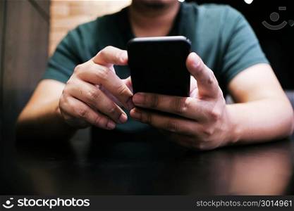 Cropped view of male hands holding cell phone with blank screen.Man using electronic gadget, typing message or checking newsfeed on social networks