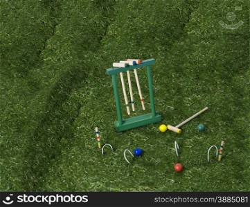 Croquet set with mallets and balls on a lawn of green grass - path included