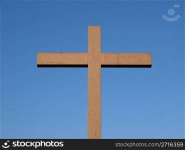Cross. A wooden Christian cross over a blue sky