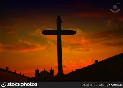 cross and church in silhouette at sunset