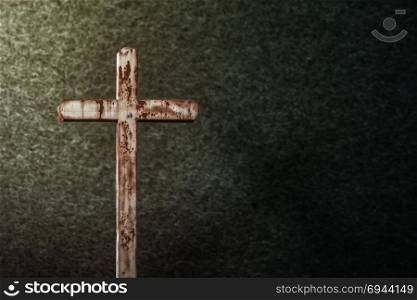Cross and grunge background with dramatic lighting as halloween theme