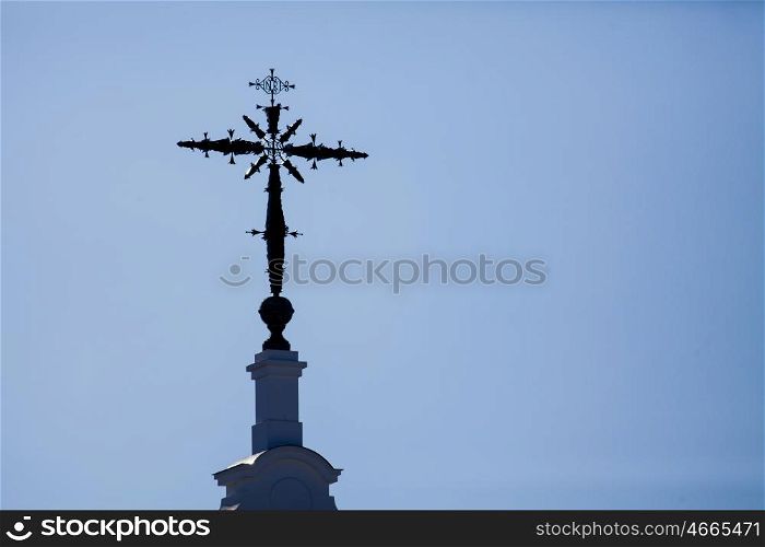 Cross atop a church with sky background&#xA;