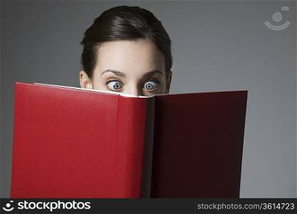 Cross-eyed Brunette and red book cover