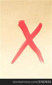 Cross mark symbol written on brown paper