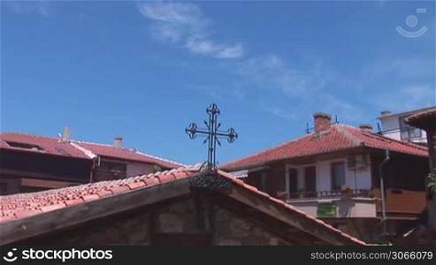 cross on the roof of the old church
