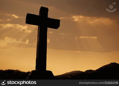 cross silhouette and the clouds at sunset