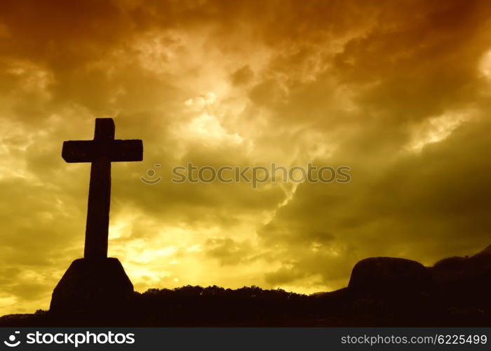 cross silhouette and the clouds at sunset