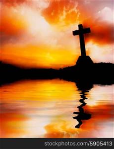 cross silhouette and the reflection on the water