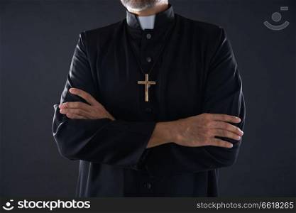 Crossed arms priest portrait senior male