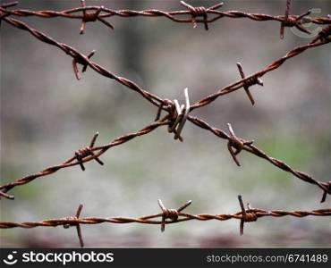 Crossed barbed wire. old rusty barbed wire