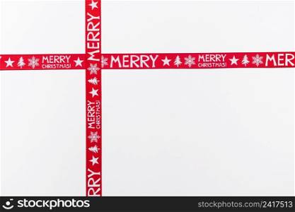 crossed red ribbons saying merry christmas
