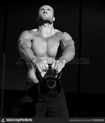 Crossfit Kettlebells swing exercise man workout at fitness gym
