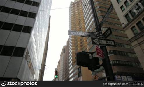 Crossroad, road sign and traffic lights, corporate buildings, Manhattan, low angle