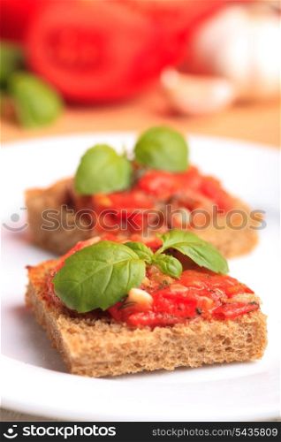 Crostini with rye bread, tomato, garlic and basil. National italian dish