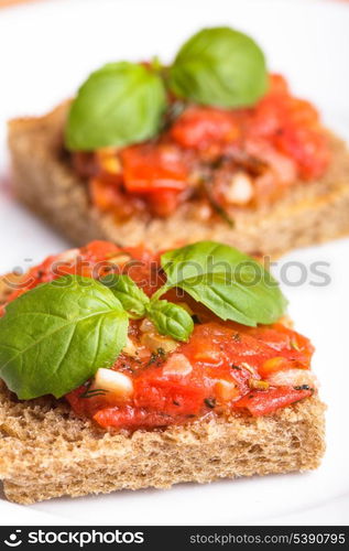 Crostini with tomato, garlic and basil. National italian dish