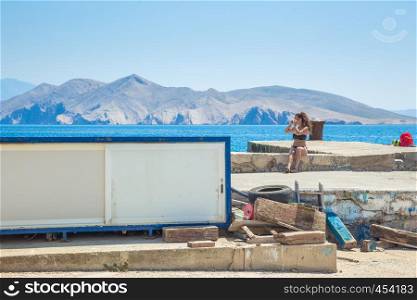 Crotia, sea, mole and peoples, girl, boats and sunny day. Travel photo. 2016 Relax at beach.