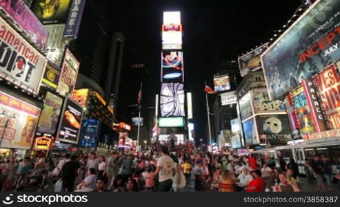 Crowd, buildings with displays and commercials, night shot, Times Square, New York City