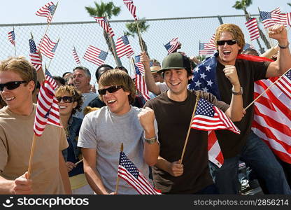 Crowd holding up American flags