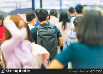 Crowd of people waiting in airport during coronavirus quarantine