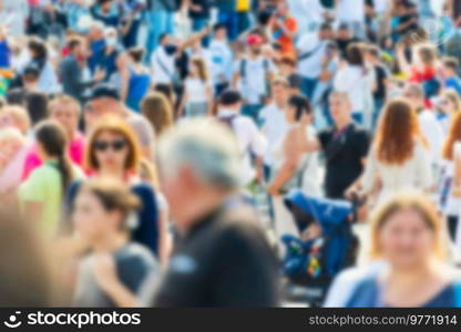 Crowd of people with blurred men and women on busy city street