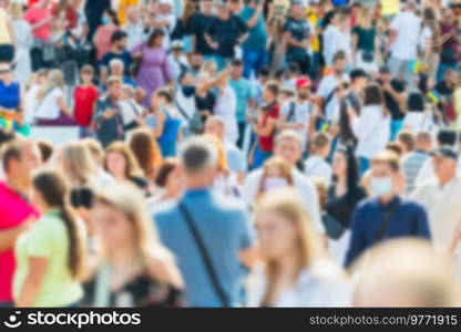 Crowd of people with blurred men and women on busy city street