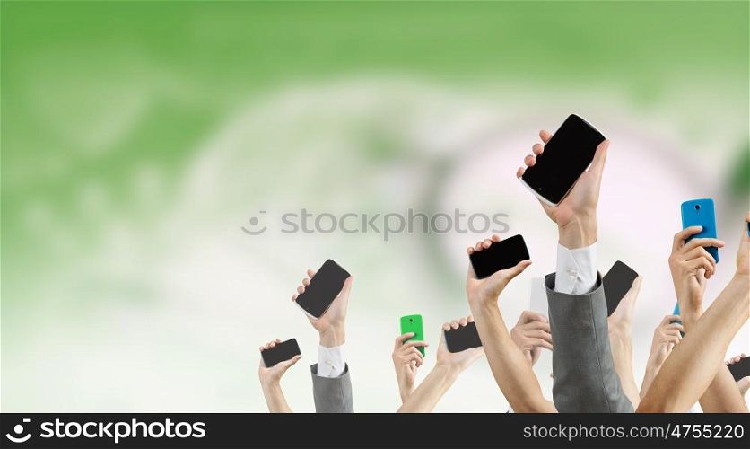 Crowd of people with phone in hands. Group of people with hands up showing mobile phones