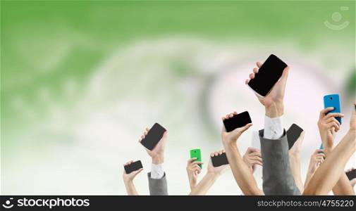 Crowd of people with phone in hands. Group of people with hands up showing mobile phones