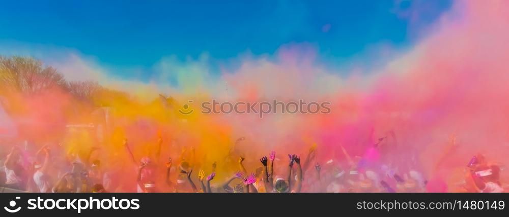 Crowd throwing bright colored powder paint in the air, The Color Run, Festival of joy