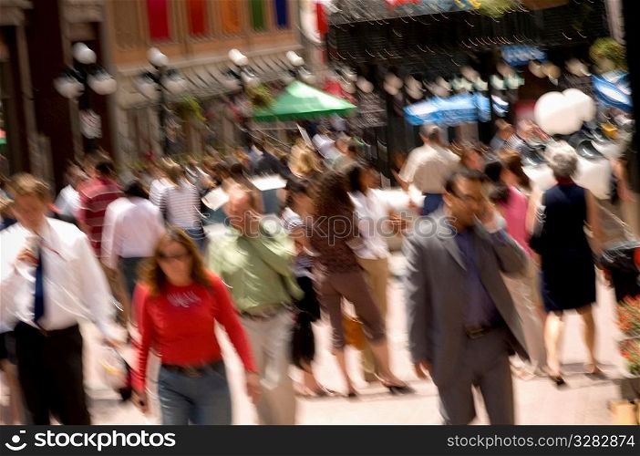 Crowded downtown sidewalk in the summer.