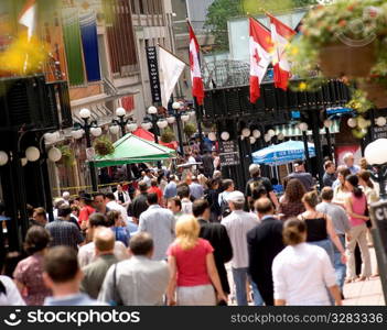 Crowded downtown sidewalk in the summer.