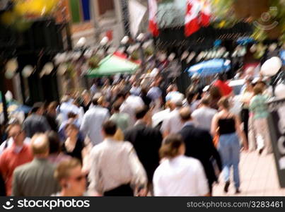 Crowded downtown sidewalk in the summer.