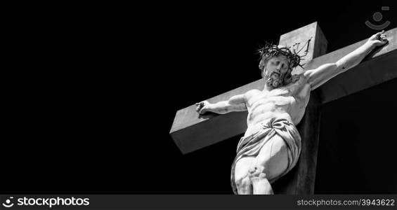 Crucifix made of marble with blue sky in background. France, Provence Region.