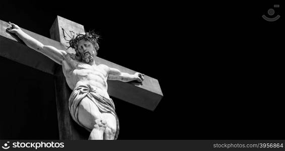 Crucifix made of marble with blue sky in background. France, Provence Region.