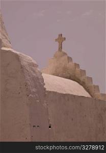 Crucifix on top of church in Mykonos Greece
