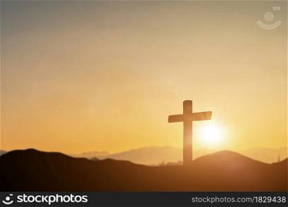 Crucifixion of jesus christ, catholic cross at sunset background. Resurrection concept